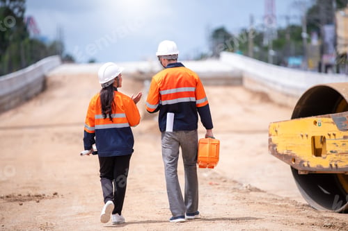 Preview: Engineers Surveyor wearing safety uniform ,helmet with equipment theodolite to measurement positioni