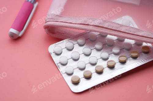 Preview: birth control pills on wooden background, close up