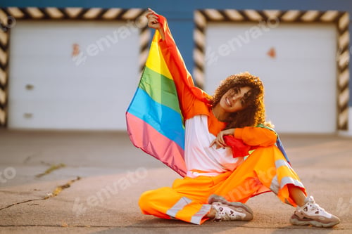 Preview: American lesbian woman holding LGBT rainbow flag. concept of happiness, love for same-sex couples.