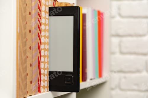 Preview: E-book reader device on background of paper books