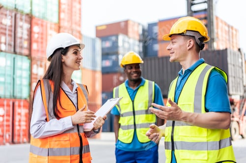 Preview: Caucasian business man and woman worker working in container terminal.