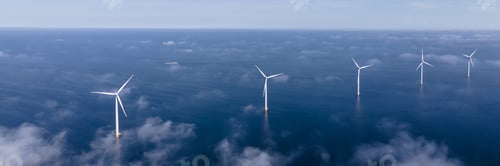 Preview: Drone Aerial view at Windmill park with windmills and a blue sky