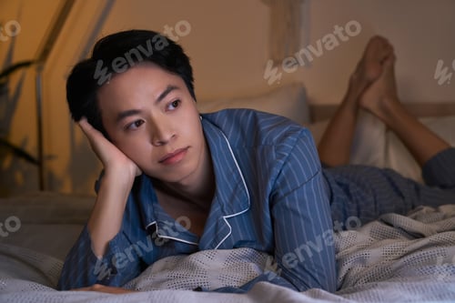Preview: Asian man during his evening moments in a modern apartment