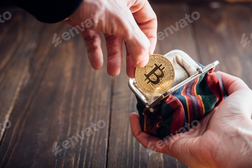 Preview: Man hand with coin. Bitcoin symbol