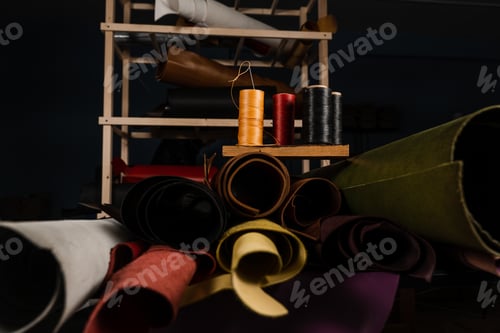 Preview: Genuine leather rolls with sewing tools in professional leather production environment