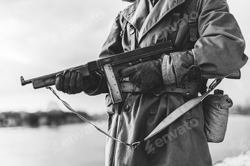 Preview: Soldier Of USA Infantry Of World War II Holds Submachine Weapon In Hands. black and white