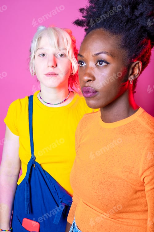 Preview: Two young diverse multicultural caucasian and black women best friends posing