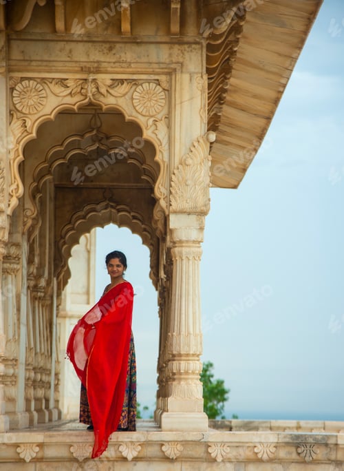 Preview: Indian woman standing between arches and Pillars.