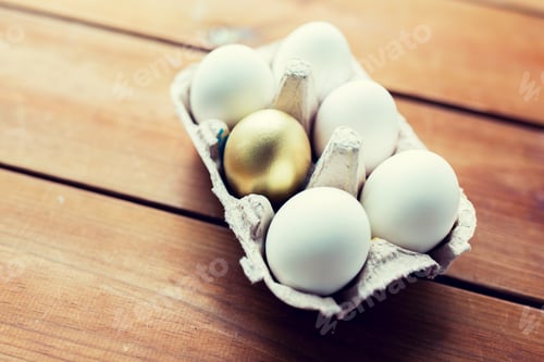 Preview: close up of white and gold eggs in egg box