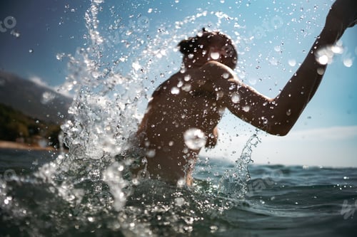 Preview: Male coming out from the water while swimming with a splash
