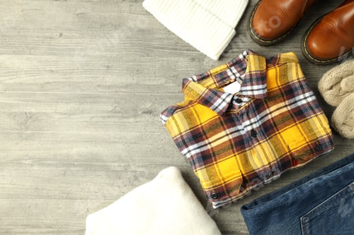 Preview: Concept of winter clothes on gray wooden table