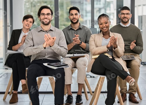 Preview: Portrait of a group of young businesspeople clapping during a conference in a modern office