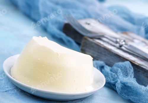 Fresh Butter Dome with Silverware and Blue Cloth
