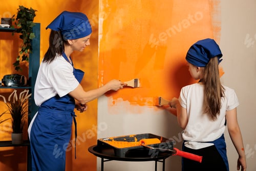 Preview: Cheerful people using orange color paint
