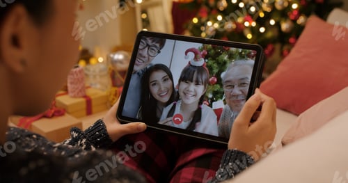 Preview: Asia happy woman relax smile laugh waving hand greet in digital tablet screen remote talk to child