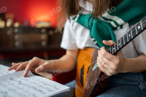 Preview: Woman hand flips through sheet music for balalaika. Ethnic musical instrument practice, tune lesson