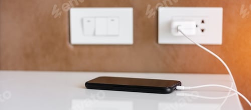 Preview: mobile smartphone charging battery on table at home or office. Technology, multiple sharing