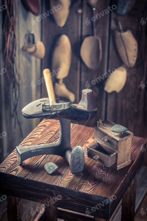 Preview: Shoes, hammer and nails in old cobbler workshop