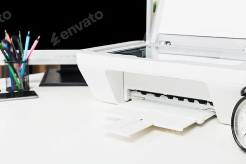 Preview: Printer on a desk with stationery and computer, showcasing a workspace setup for productivity and