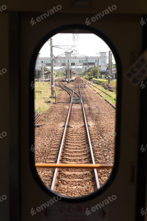 Preview: View of train tracks from an oval train window