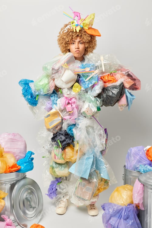 Preview: Vertical shot of displeased irritated woman picked plastic litter considers pollution problem collec
