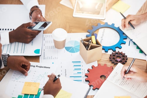 Preview: Hands, teamwork and planning with a marketing team working on a table full of paperwork, gears and
