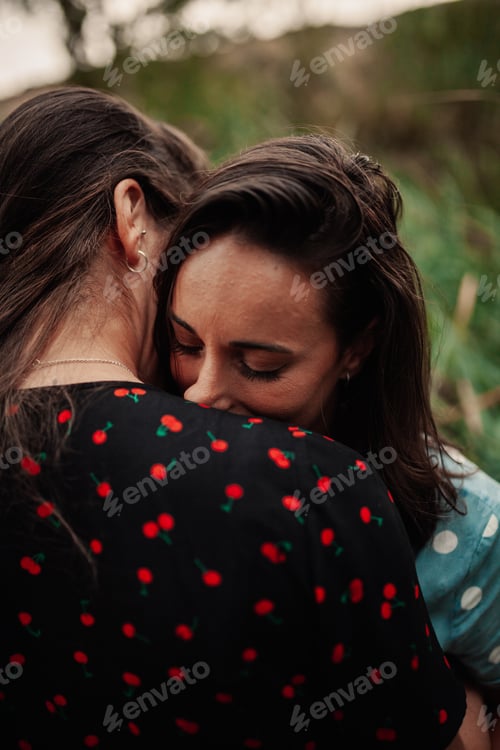 Preview: Two young women embraced on the field