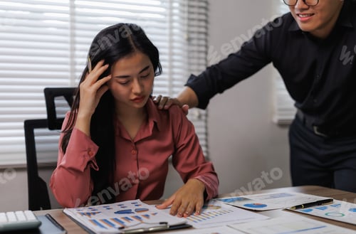 Preview: Manager comforting stressed young accountant woman at work