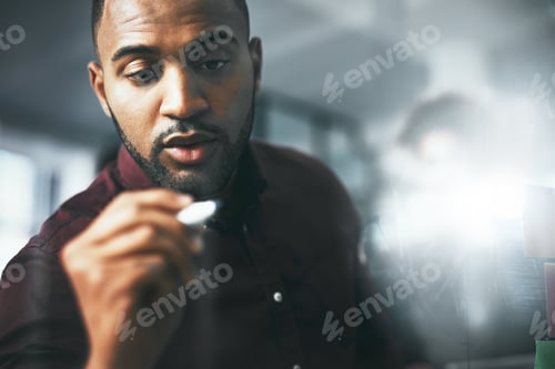 Preview: Shot of a young businessman brainstorming in a modern office