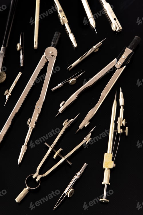 Preview: Set of old different compasses. Retro metal compasses and drafting tools on a black background