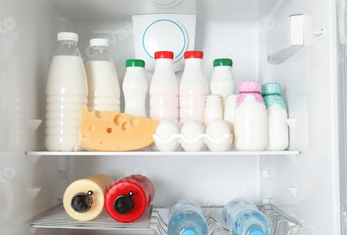 Preview: Open refrigerator with many different products, closeup