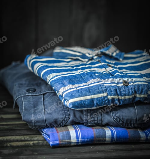 Preview: stylish men's clothing, shirts folded in a pile