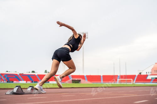 Preview: Asian young sportswoman sprint on a running track outdoors on stadium. A
