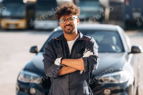 Preview: Posing, with arms crossed. Mechanic is with the car outdoors