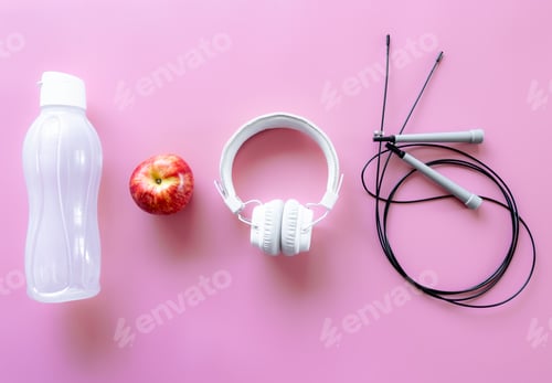 Preview: Sports equipment items on pink background, flat lay.