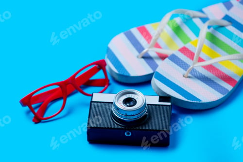 Preview: colorful sandals, glasses and camera on the wonderful blue background