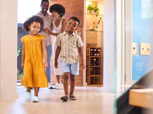 Preview: Family Returning Home Opening Front Door And Children Running In