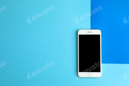 Preview: Modern phone on blue background, top view. Space for text