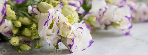 Preview: A bouquet of light white violet eustoma on marble background. Romantic wedding background. Banner