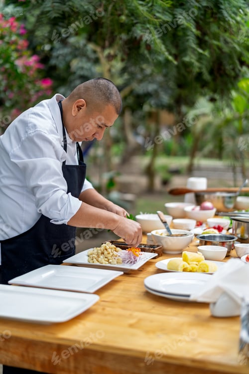 Preview: Chef preparing fresh ingredients outdoors in country restaurant