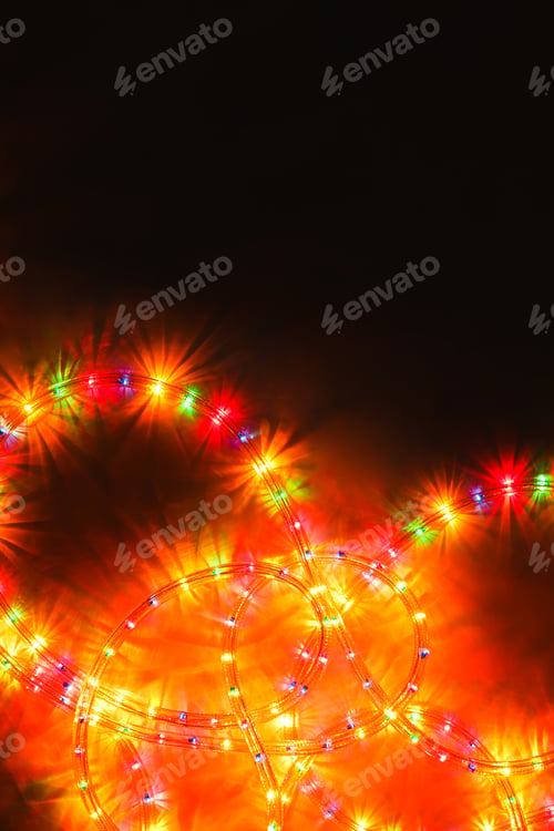 Preview: Colored light christmas garland illumination background on black, unfocused.