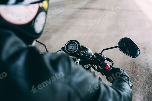 Preview: Over shoulder view of male motorcyclist on motorcycle