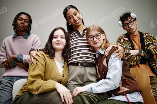 Preview: Diverse Group of Young Adults Smiling and Posing Together Indoors