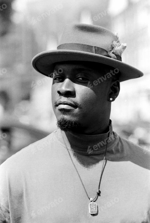 Preview: Classic monochromatic portrait of man with a hat looking at camera.