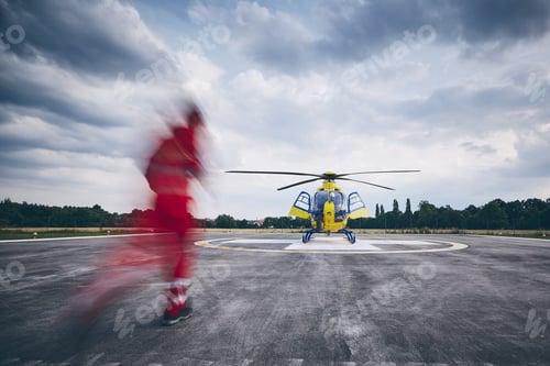Preview: Alarm for helicopter emergency medical service. Paramedic running to helicopter on heliport.