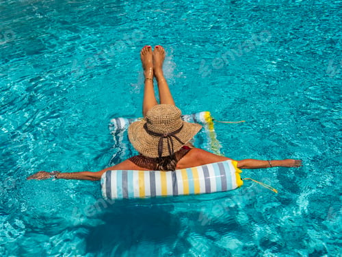 Preview: woman in luxury spa resort near the swimming pool.