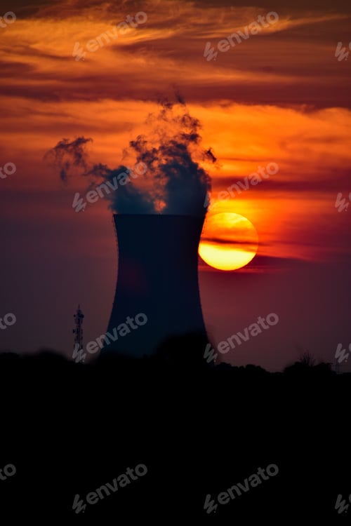 Preview: Vertical of a beautiful sunset over the smoking nuclear power plant.