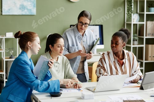 Preview: Business team using laptop at meeting