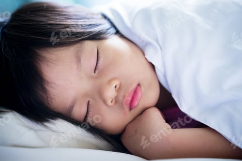 Preview: Headshot of child girl sleep on her bed. Close up little kid sleeping.