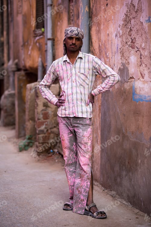Preview: Man standing confidently in a narrow alley
